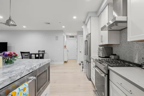 a kitchen with sink a stove and cabinets