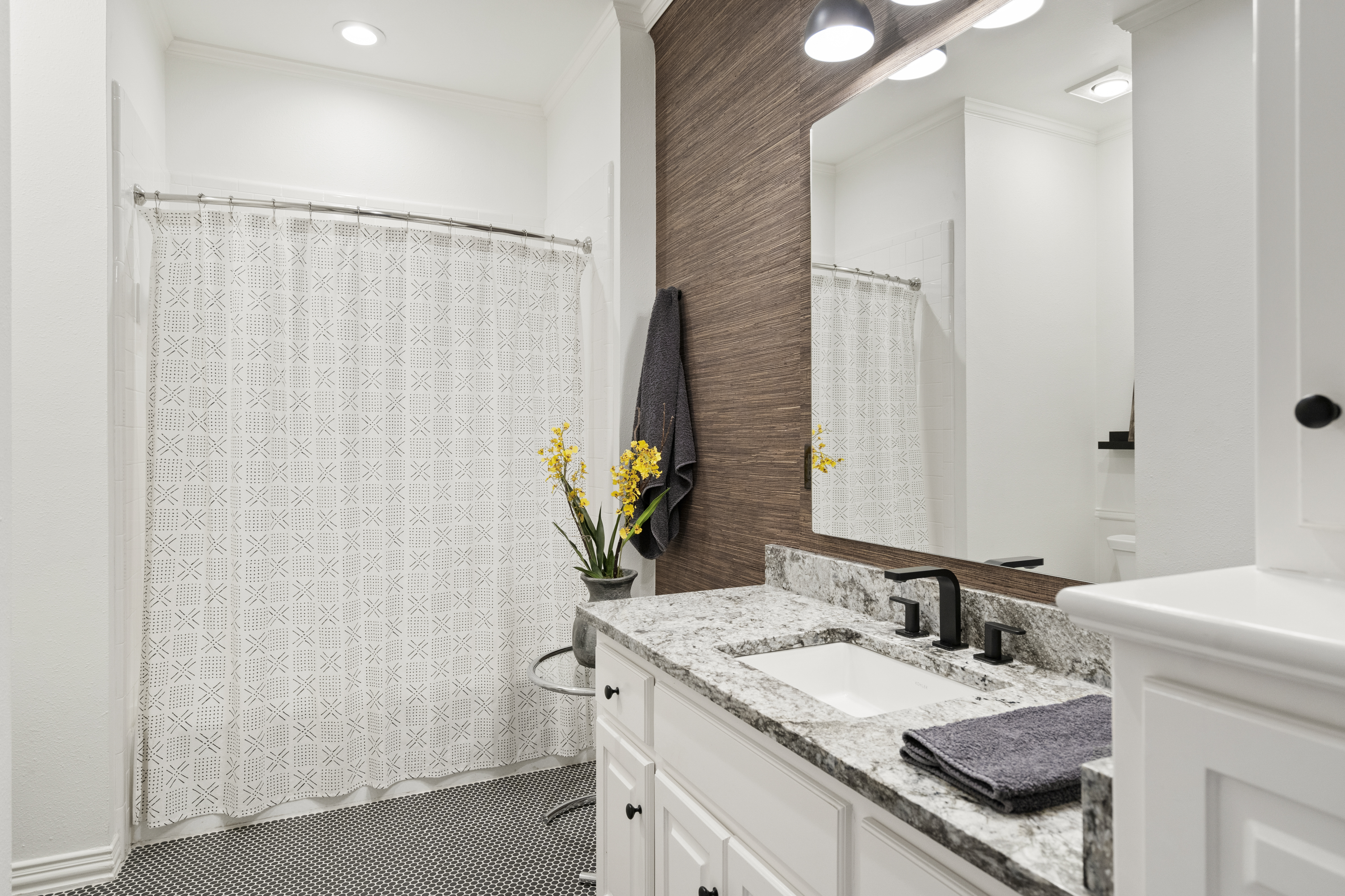 6607 Meadow Road Dallas, TX 75230 - Photo 24 of 32 a bathroom with a granite countertop sink and a mirror