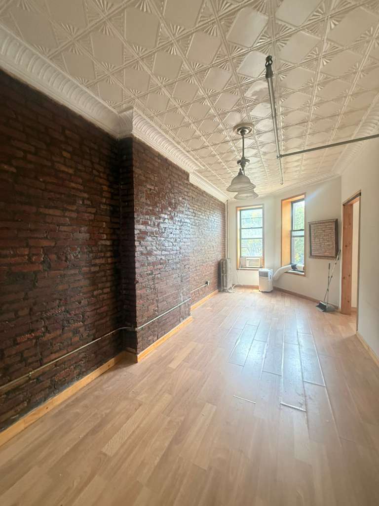 313 Van Buren Street Brooklyn, NY 11221 - Photo 14 of 20 a view of livingroom with hardwood floor and window