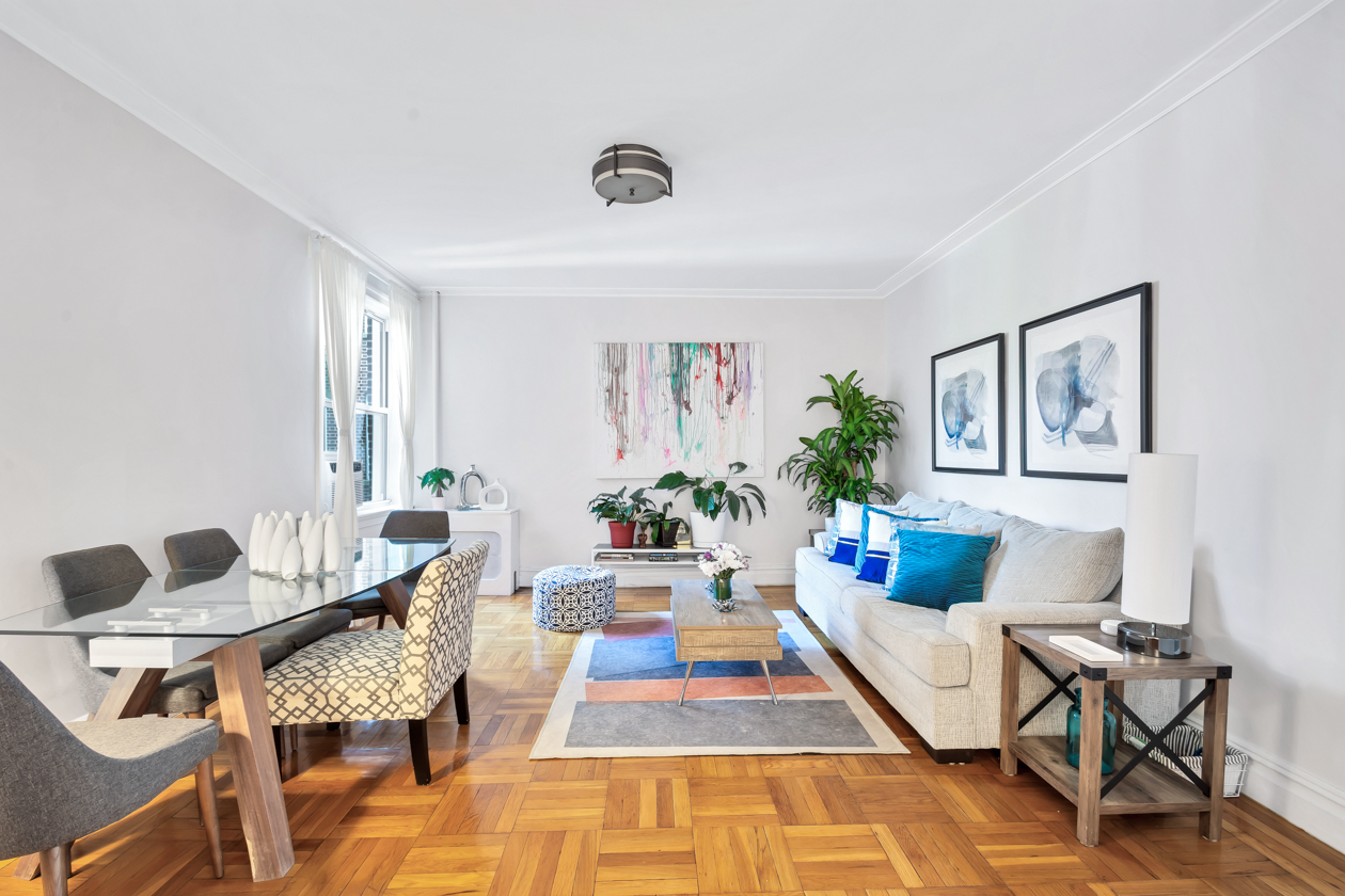 720 West 173rd Street, Unit 38 Manhattan, NY 10032 - Photo 2 of 9 a living room with furniture and a rug
