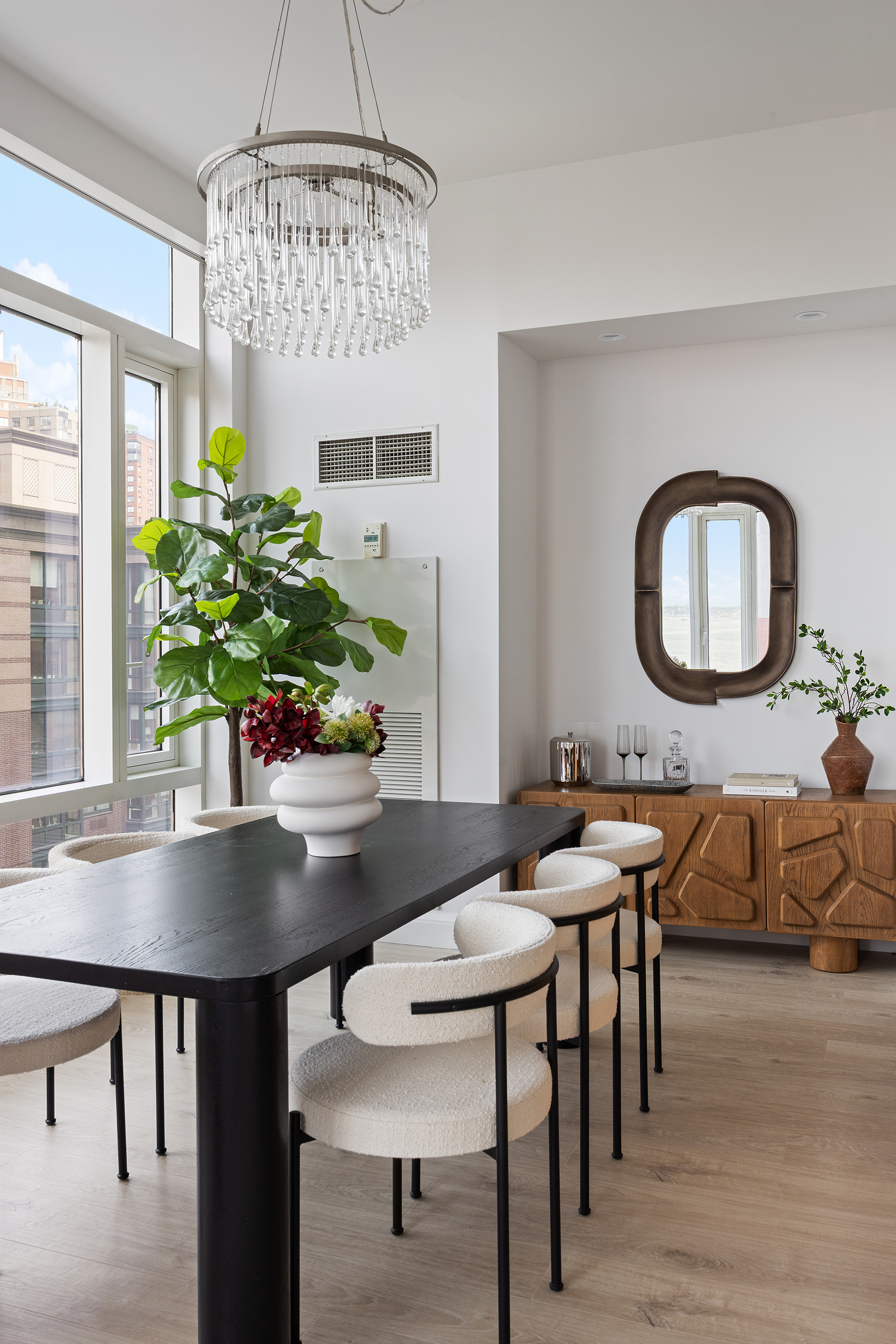70 Little West Street, Unit 7L Manhattan, NY 10004 - Photo 3 of 25 a view of a dining room with furniture window and wooden floor