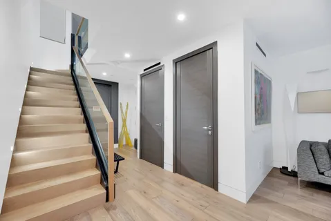 a view of entryway with wooden floor and stairs