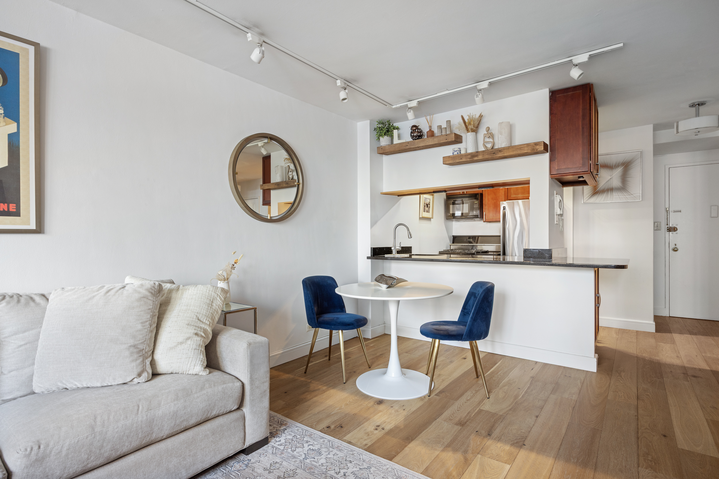 415 East 85th Street, Unit 7J Manhattan, NY 10028 - Photo 3 of 9 a living room with furniture and a wooden floor