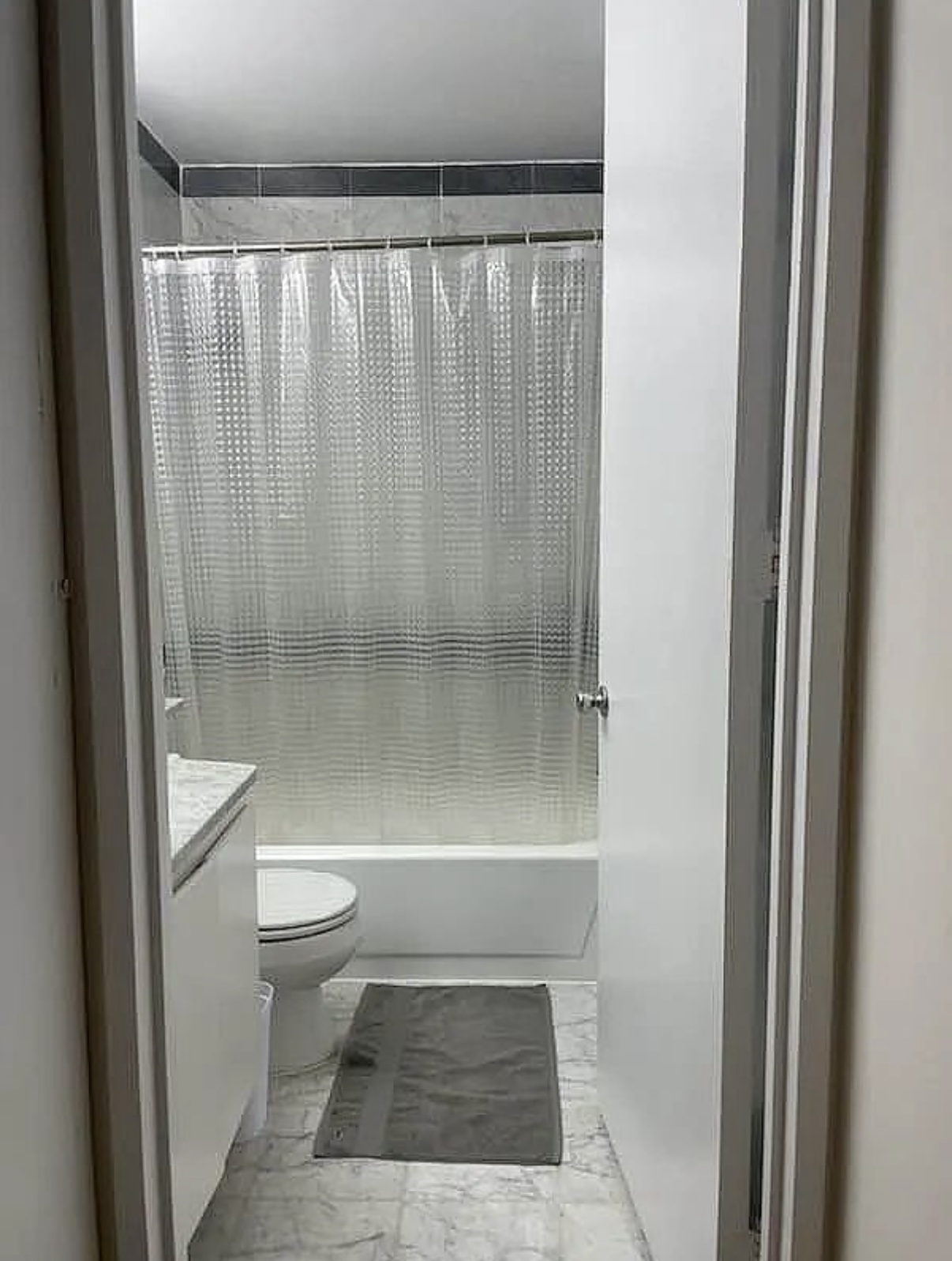 500 West 43rd Street, Unit 4E Manhattan, NY 10036 - Photo 5 of 11 a bathroom with a shower a toilet and a sink