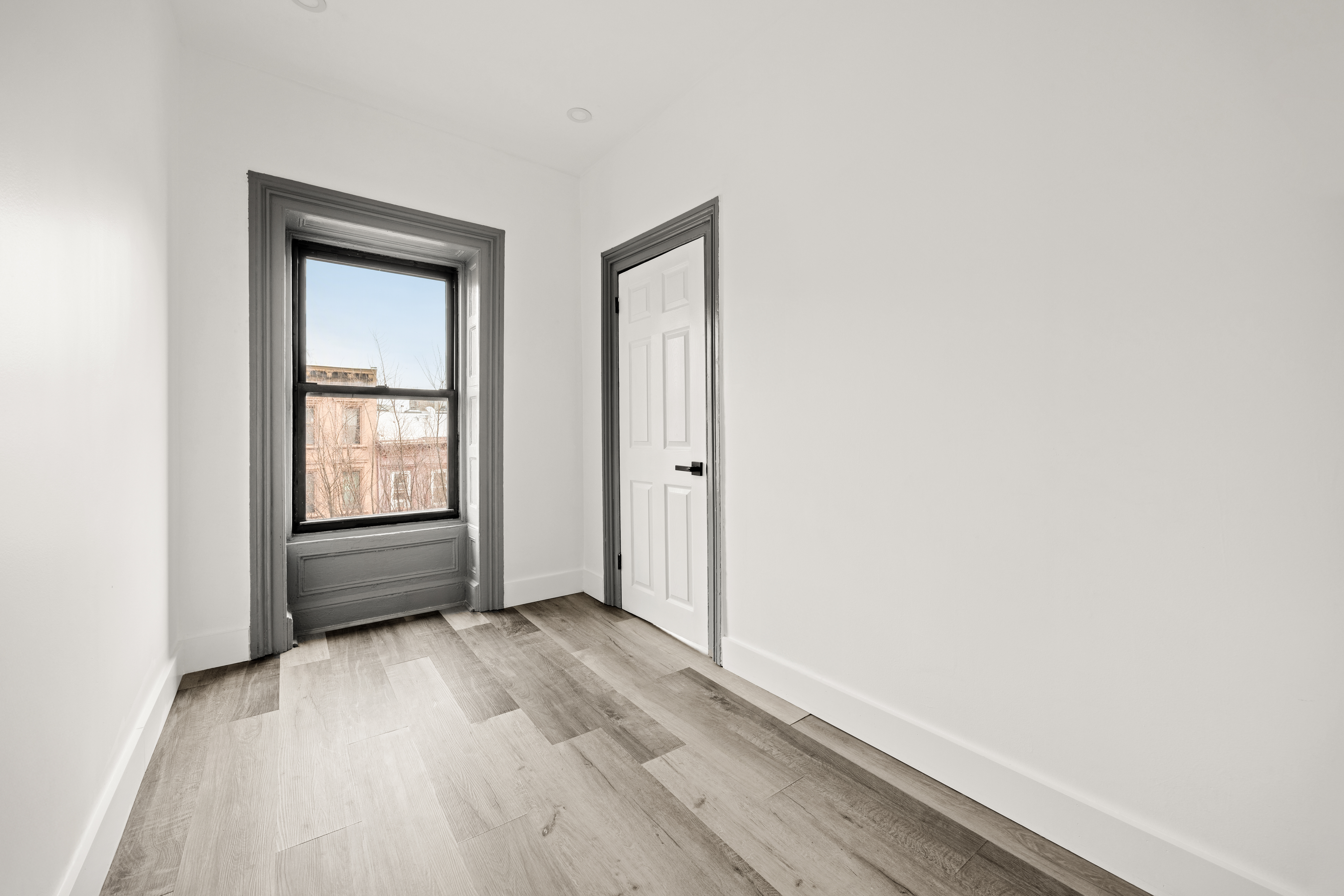 126 Quincy Street, Unit 3 Brooklyn, NY 11216 - Photo 10 of 11 an empty room with wooden floor and windows