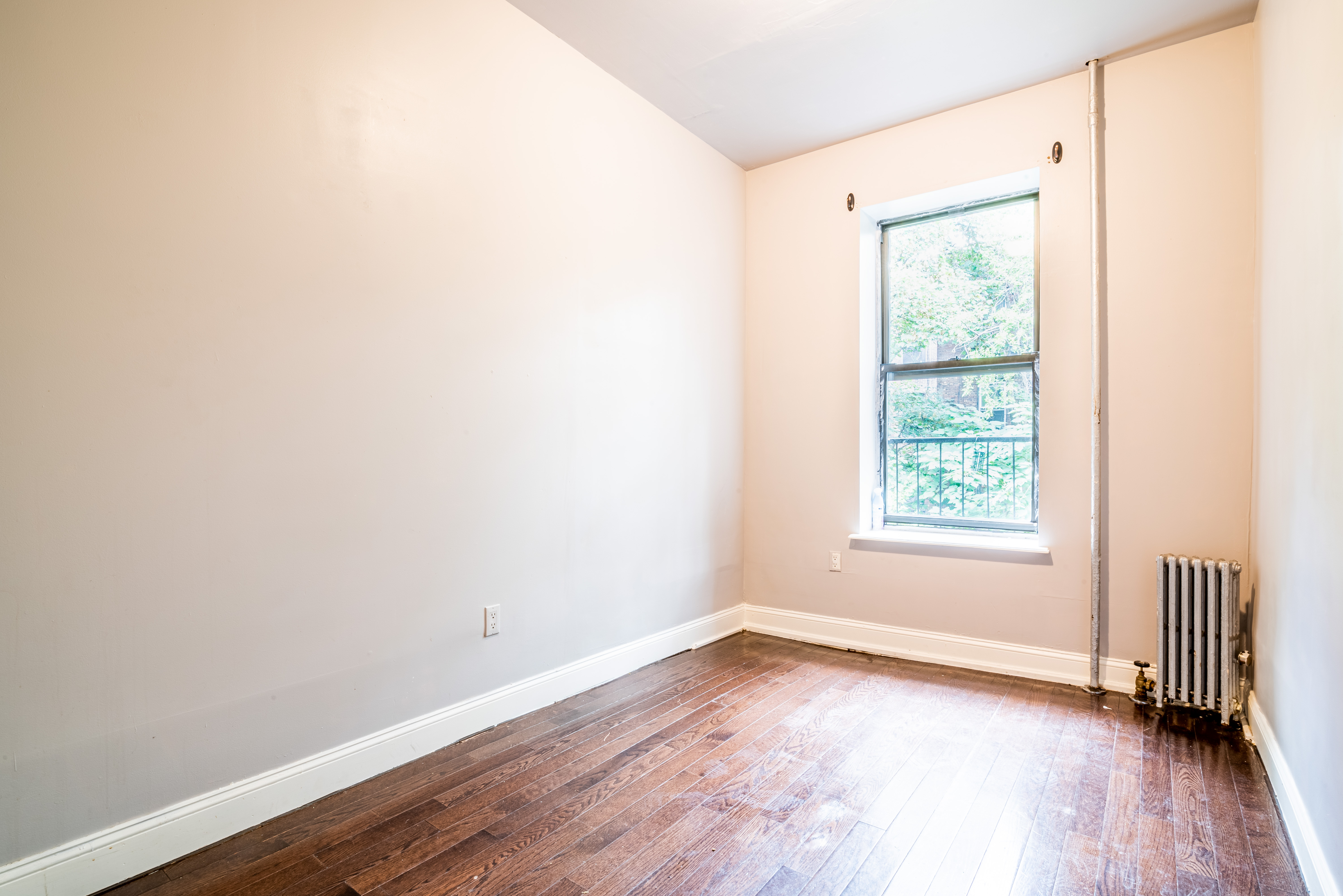 681 Sterling Place, Unit 2L Brooklyn, NY 11216 - Photo 6 of 8 an empty room with wooden floor and windows