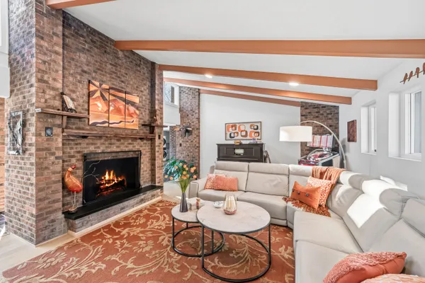 a living room with furniture and a fireplace