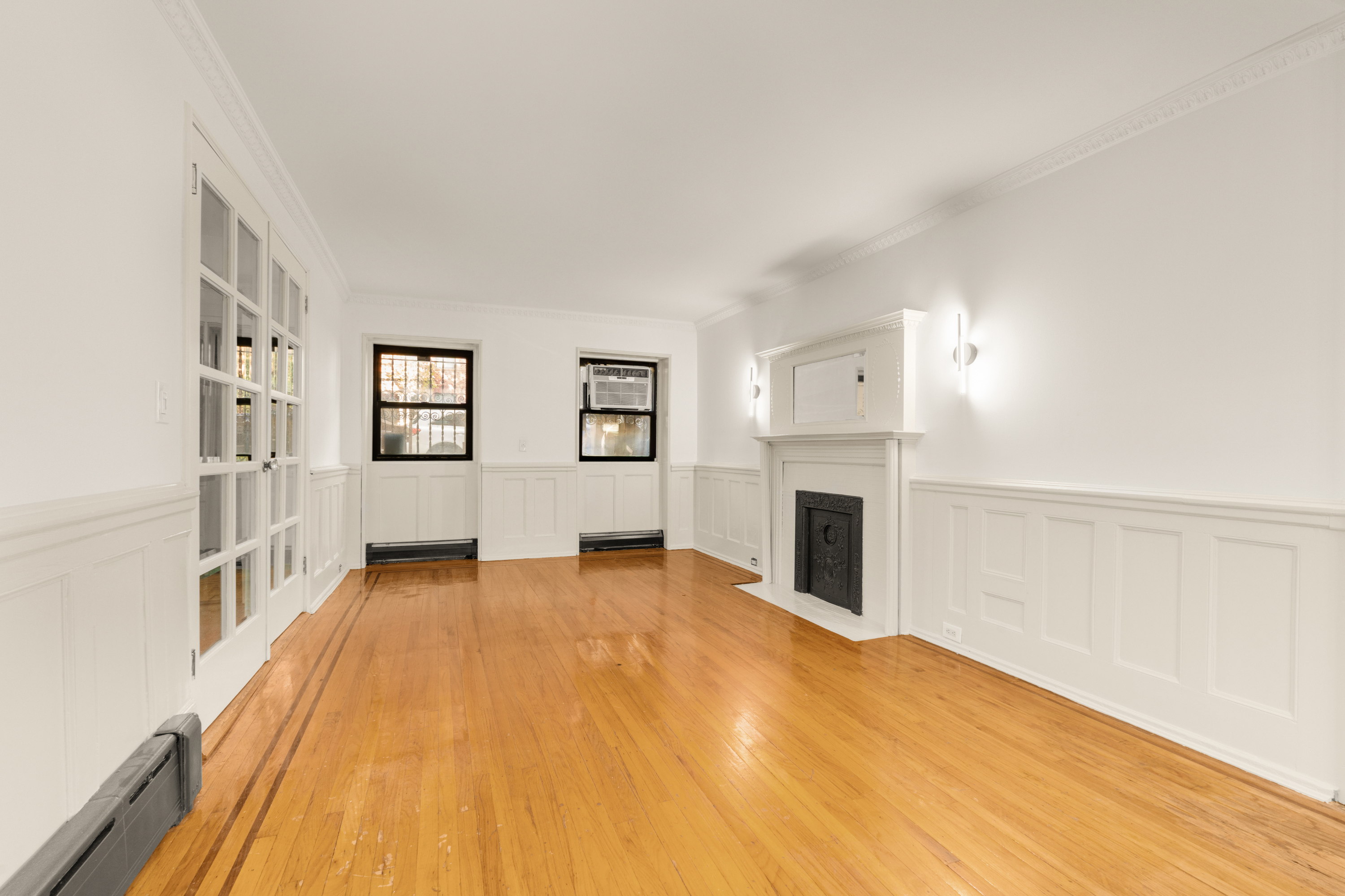 688 Saint Marks Avenue, Unit GARDEN Brooklyn, NY 11216 - Photo 6 of 13 a view of a livingroom with wooden floor and a fireplace