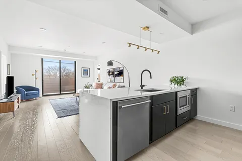 a spacious bathroom with a granite countertop sink a mirror and vanity