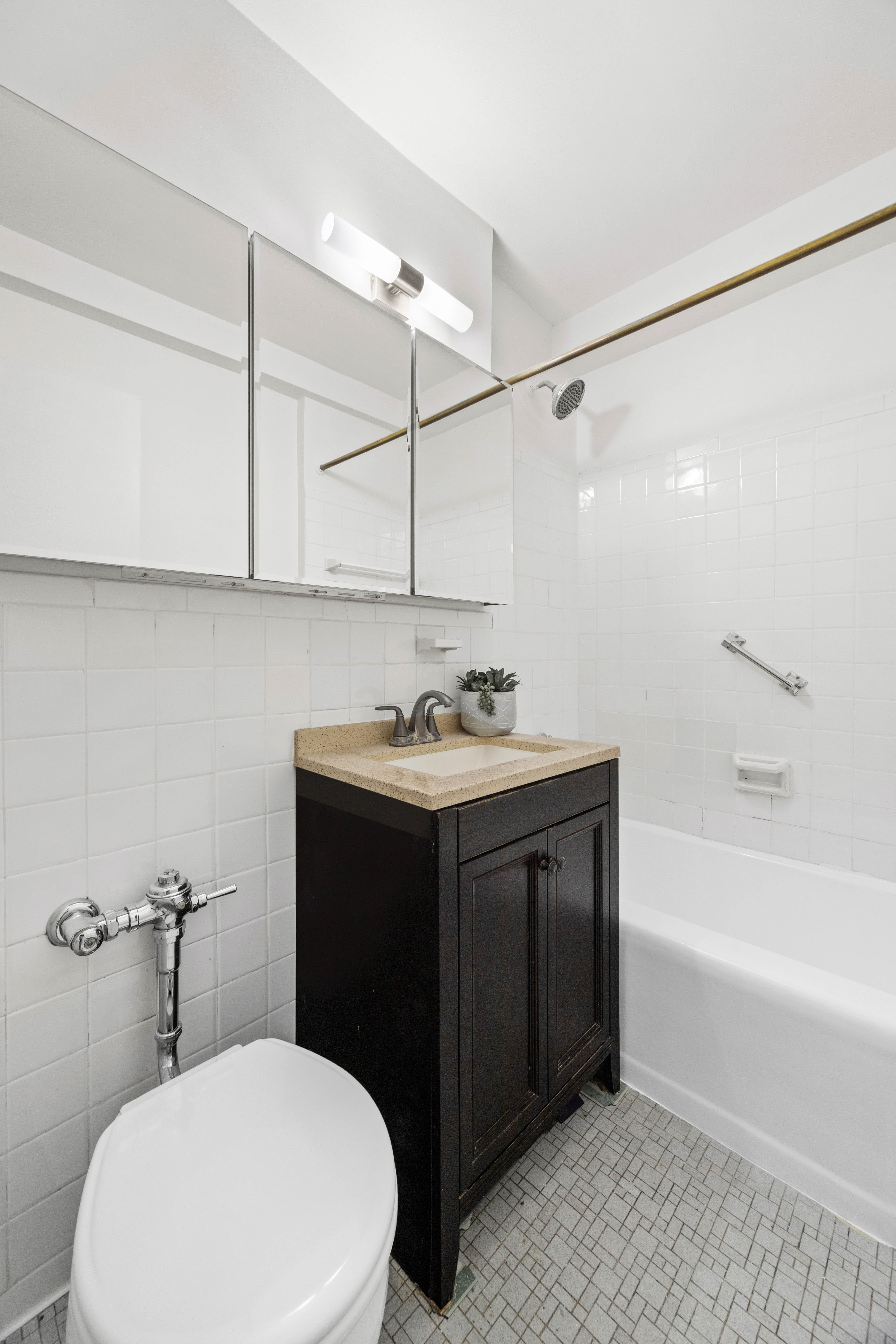155 East 38th Street, Unit 8A Manhattan, NY 10016 - Photo 7 of 8 a bathroom with a sink vanity mirror and toilet