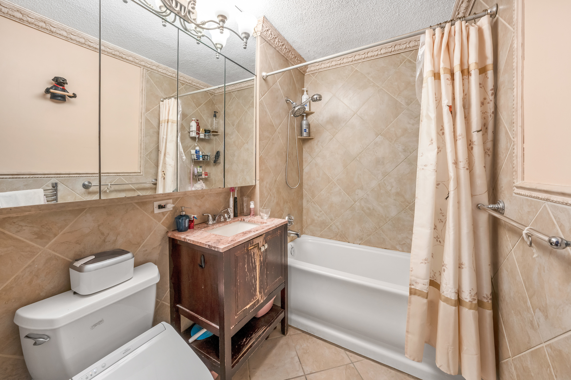 4-74 48th Avenue, Unit 27A Queens, NY 11109 - Photo 16 of 17 a bathroom with a sink toilet and shower