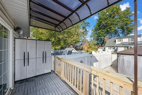 a view of balcony with wooden floor and seating space