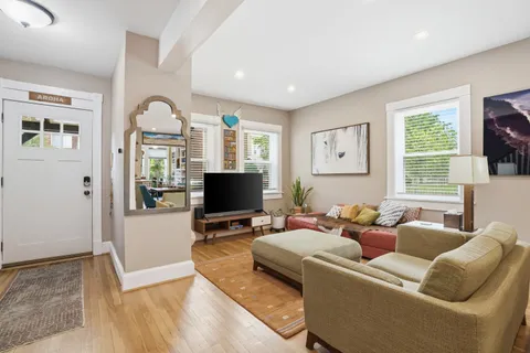 a living room with furniture and a flat screen tv