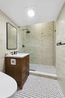 a bathroom with a sink a mirror and shower