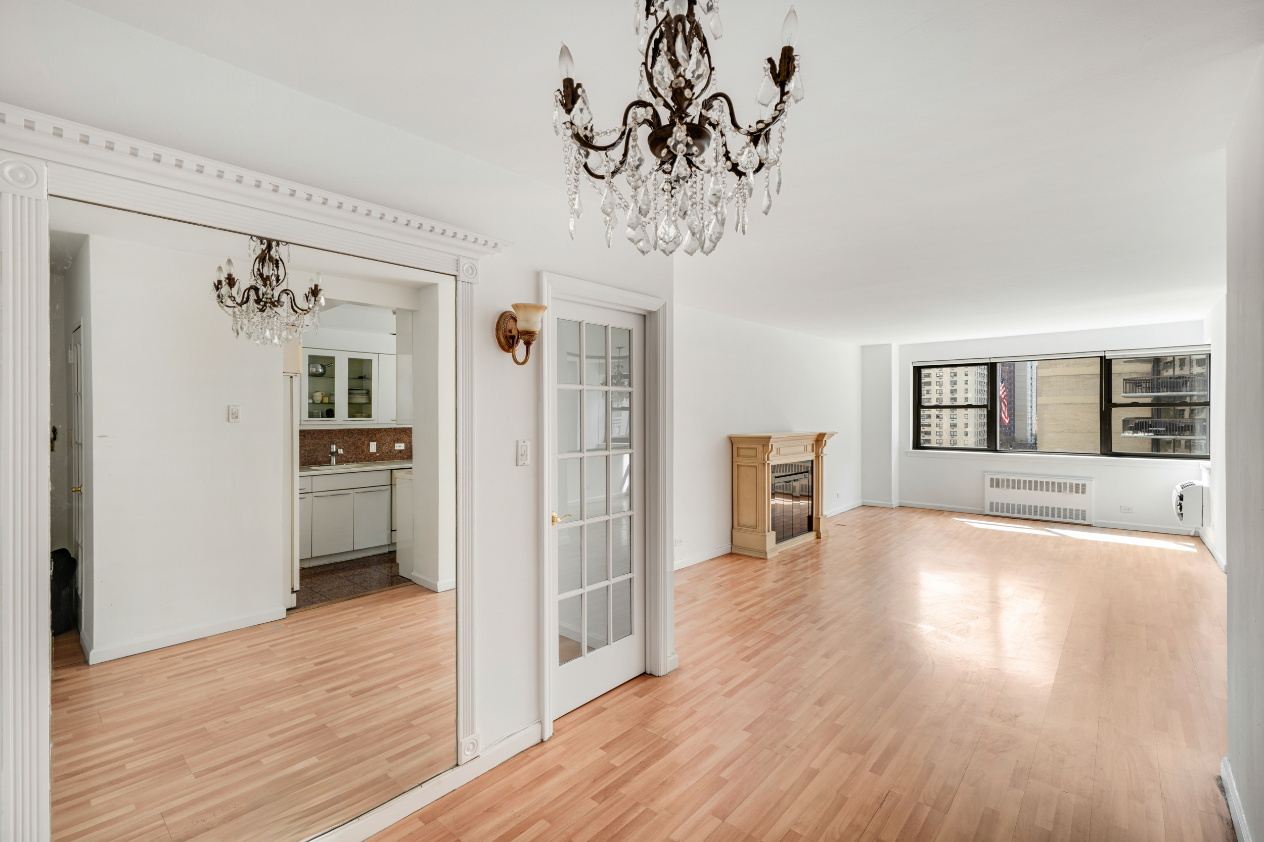 357 East 57th Street, Unit 5D Manhattan, NY 10022 - Photo 14 of 23 a view of a livingroom with wooden floor and kitchen space