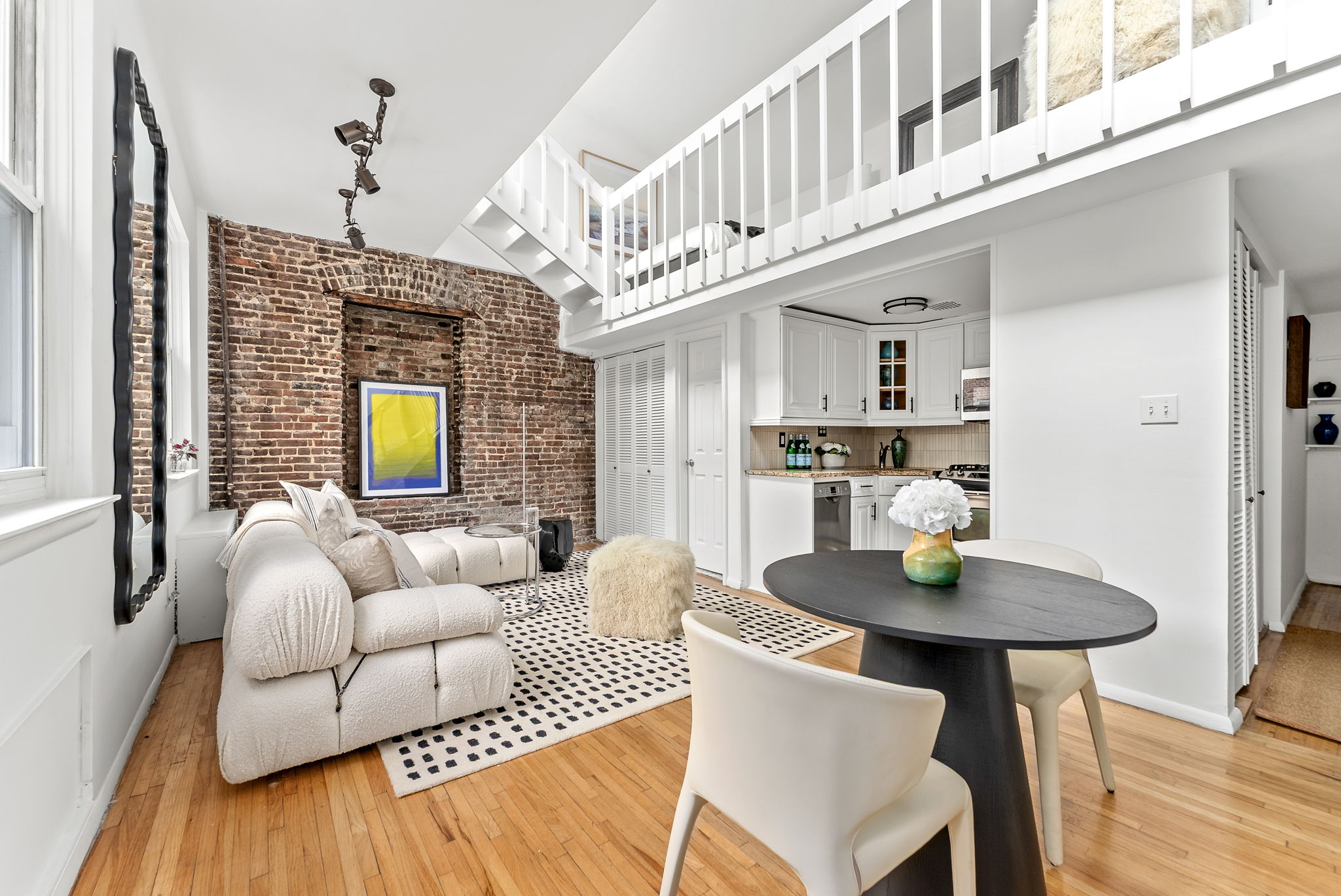 207 East 21st Street, Unit 6E Manhattan, NY 10010 - Photo 4 of 12 a living room with furniture and a chandelier