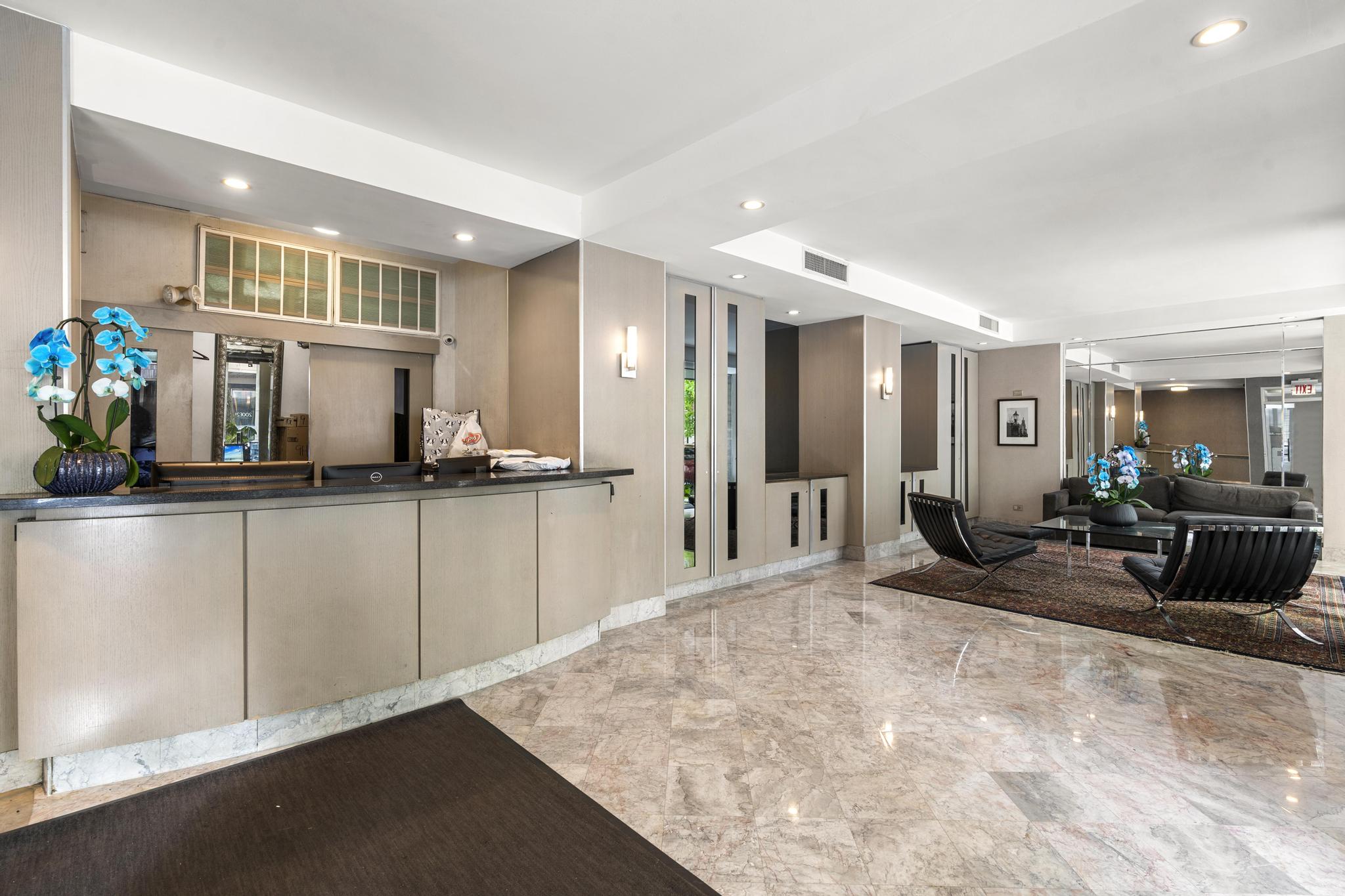 201 East 21st Street, Unit 8E Manhattan, NY 10010 - Photo 8 of 9 a view of a living room kitchen and a chandelier