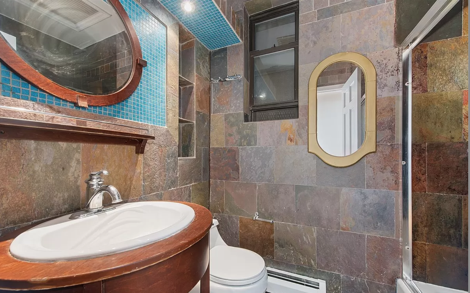 218 3rd Avenue, Unit 2 Manhattan, NY 10003 - Photo 8 of 9 a bathroom with a toilet a sink and mirror