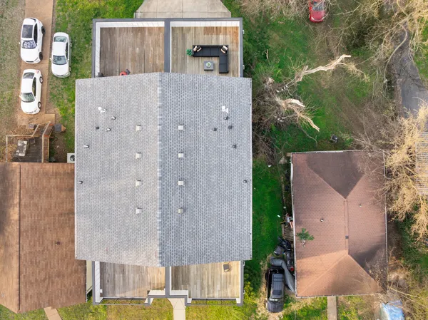an aerial view of a house with a yard