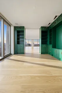 a living room with a furniture and a large window