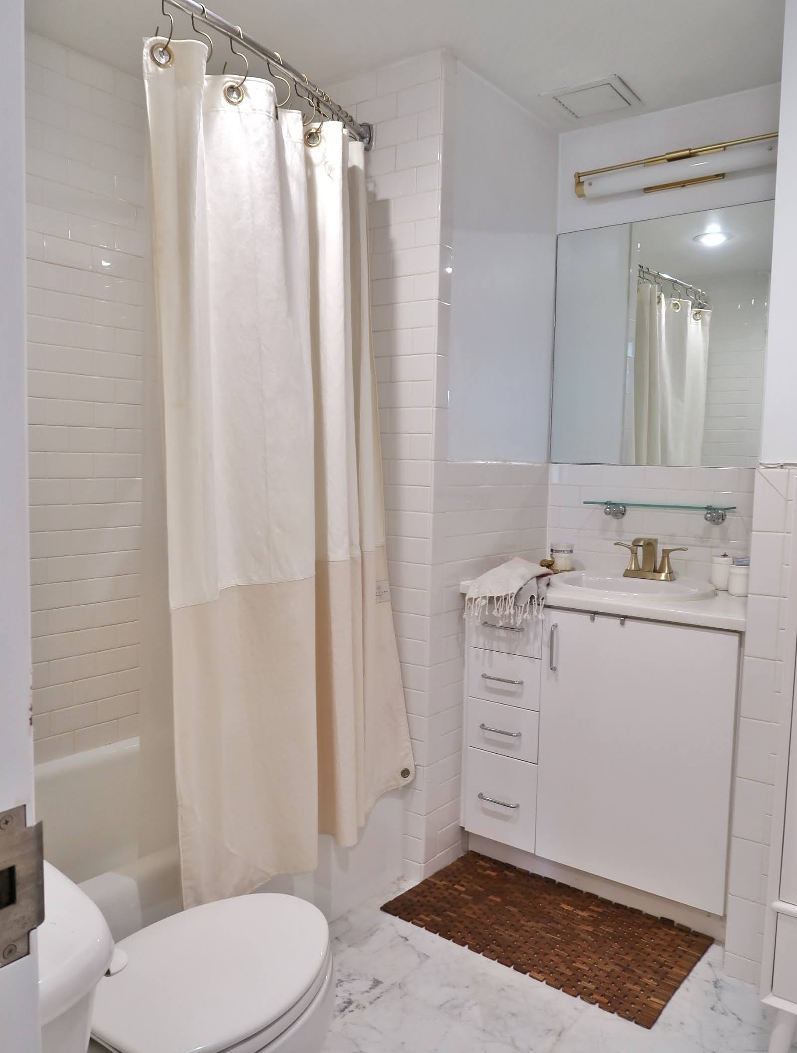 296 East 2nd Street, Unit 4G Manhattan, NY 10009 - Photo 7 of 14 a bathroom with a sink a toilet and shower