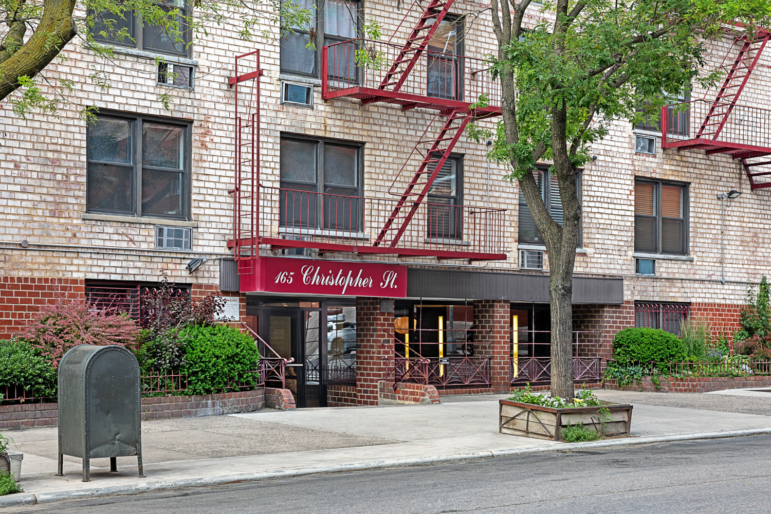165 Christopher Street, Unit 1DD Manhattan, NY 10014 - Photo 8 of 14 a view of a brick building with many windows