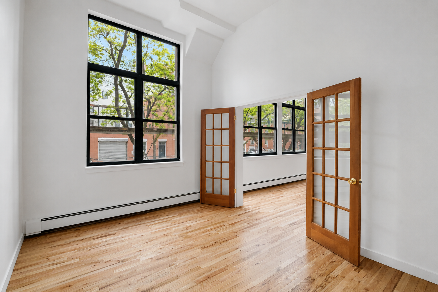 110 Clifton Place, Unit 2B Brooklyn, NY 11238 - Photo 3 of 7 a view of an empty room with window and wooden floor