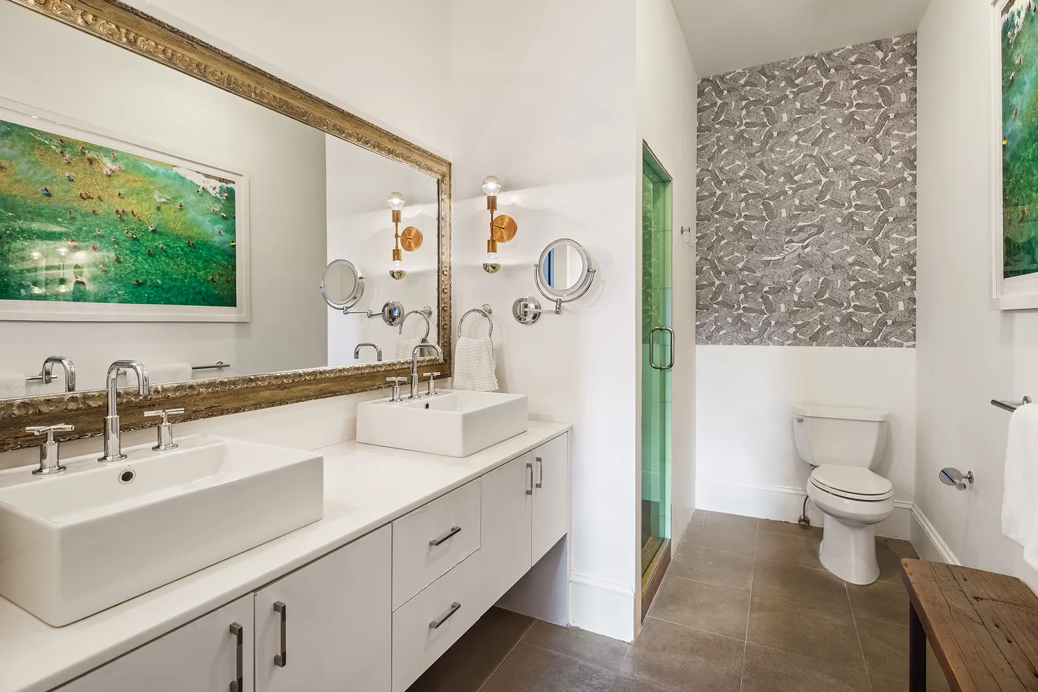 a bathroom with a double vanity sink toilet and a mirror