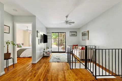 a bedroom with furniture and a wooden floor