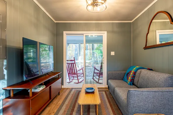 a kitchen with stainless steel appliances wooden floor and a refrigerator
