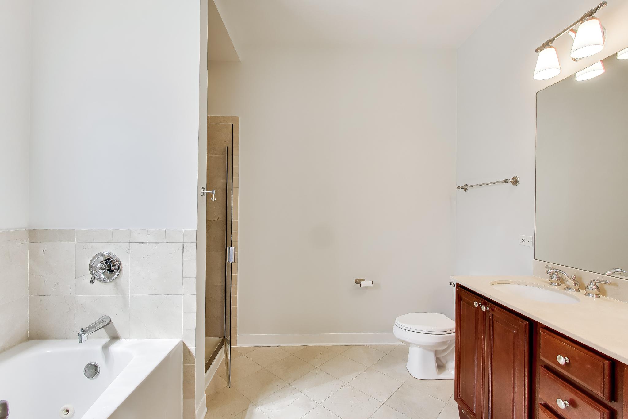 4845 North Springfield Avenue, Unit 2 Chicago, IL 60625 - Photo 26 of 32 a bathroom with a sink a toilet and shower