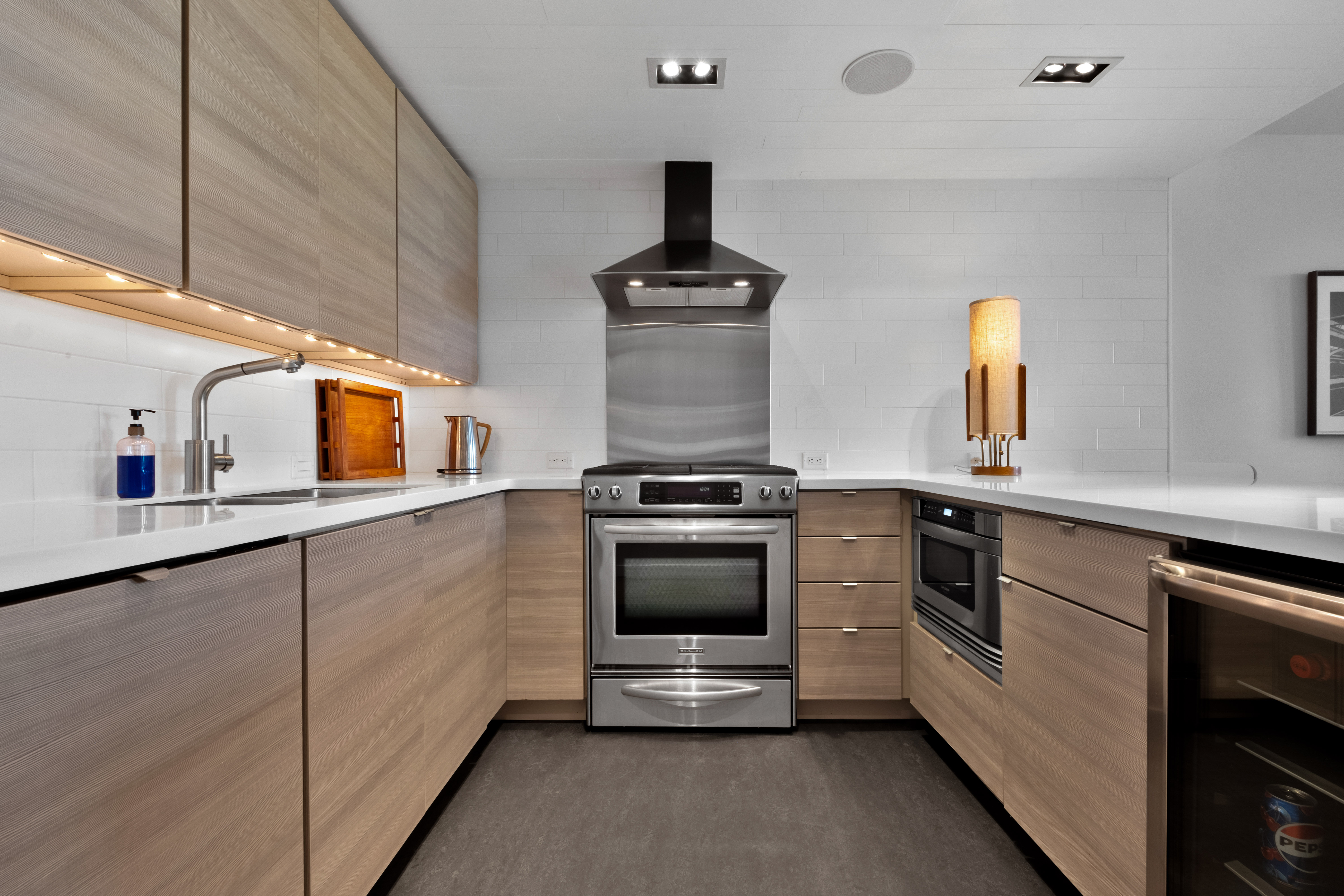 256 1/2 South 3rd Street Philadelphia, PA 19106 - Photo 21 of 73 a kitchen with stainless steel appliances a stove and white cabinets