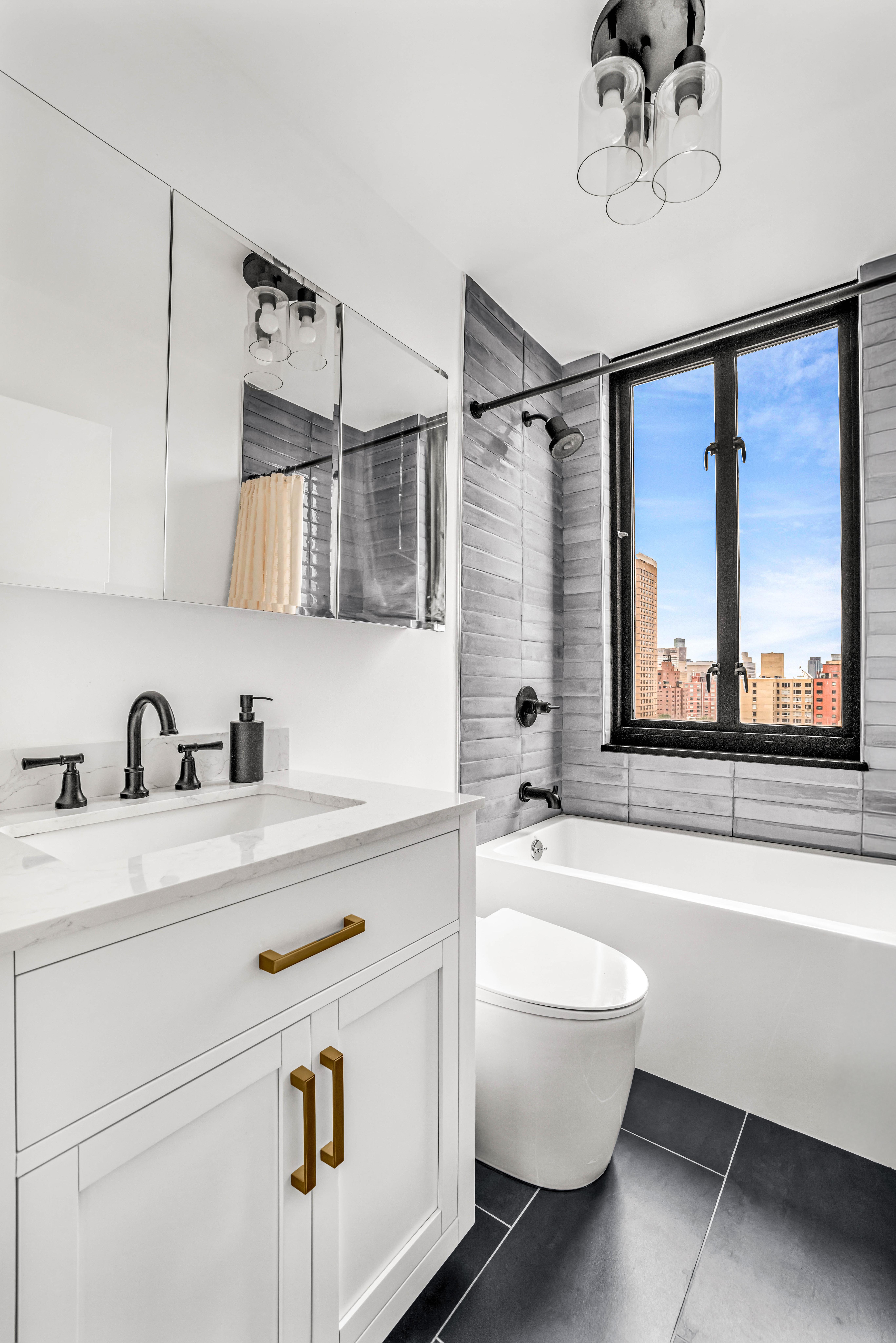 407 Park Avenue South, Unit 18B Manhattan, NY 10016 - Photo 4 of 8 a bathroom with a sink a bathtub and a window