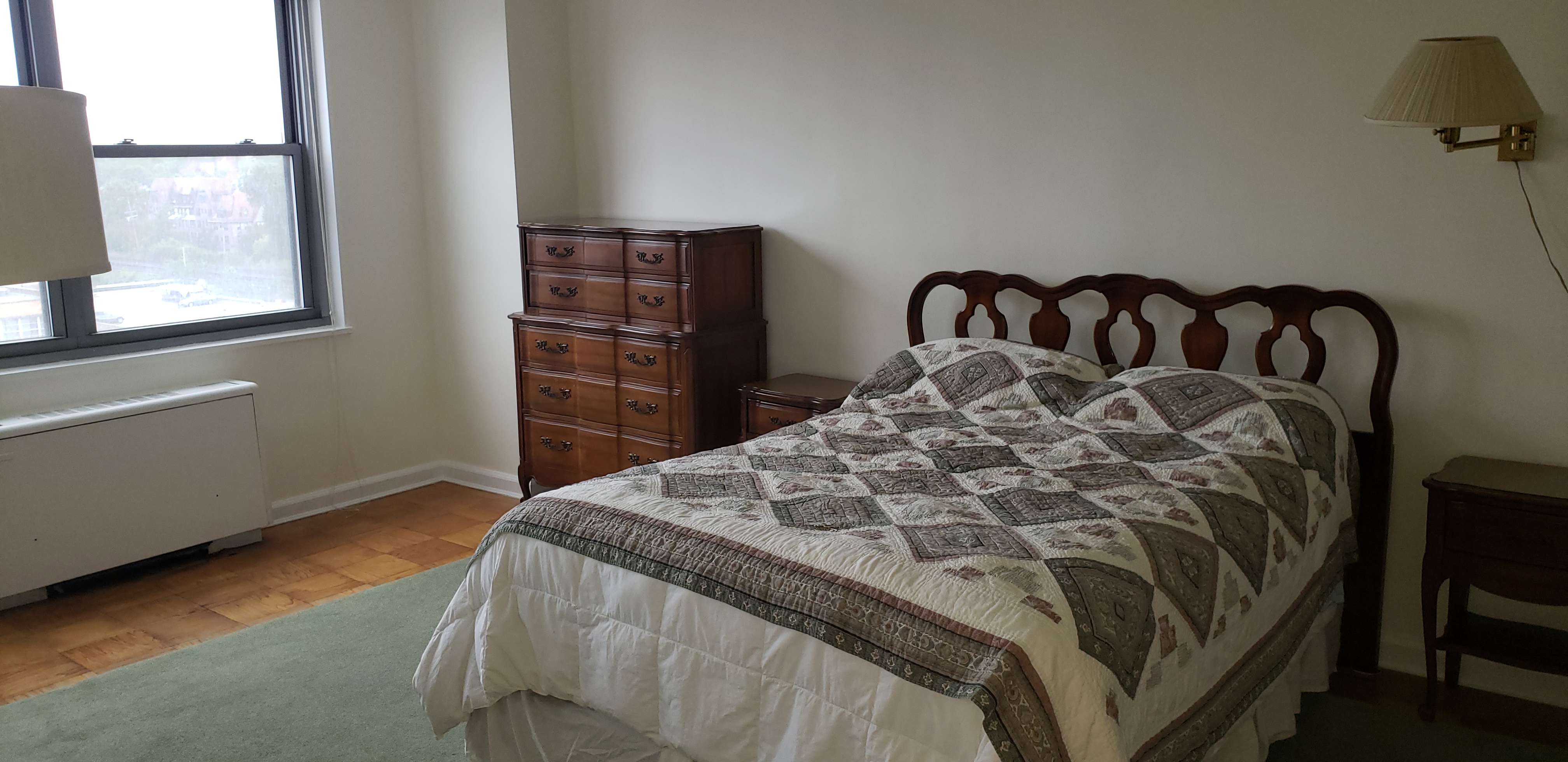 70-25 Yellowstone Boulevard, Unit 11D Queens, NY 11375 - Photo 9 of 25 a bed sitting in a bedroom next to a window