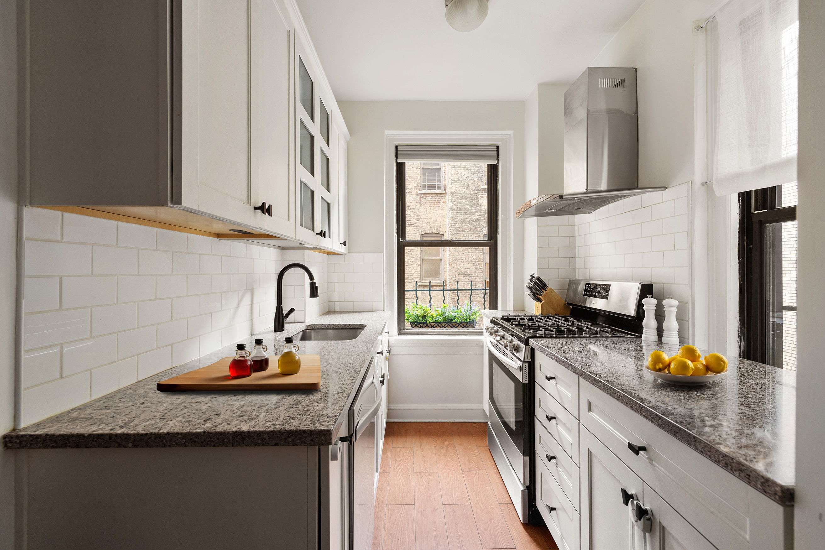 60 East 96th Street, Unit 6C Manhattan, NY 10128 - Photo 4 of 9 a kitchen with granite countertop a sink stainless steel appliances and cabinets