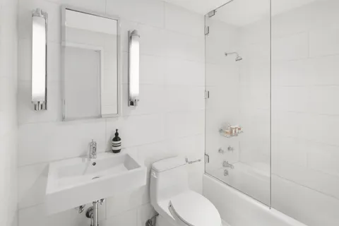 a bathroom with a sink toilet and shower