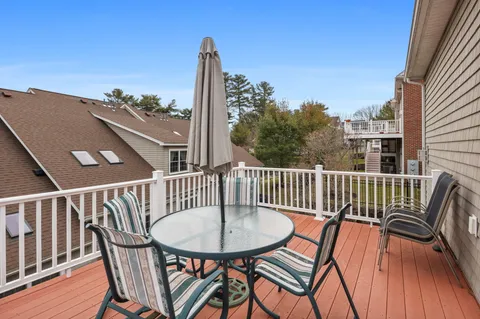 a view of a balcony with a table and chairs
