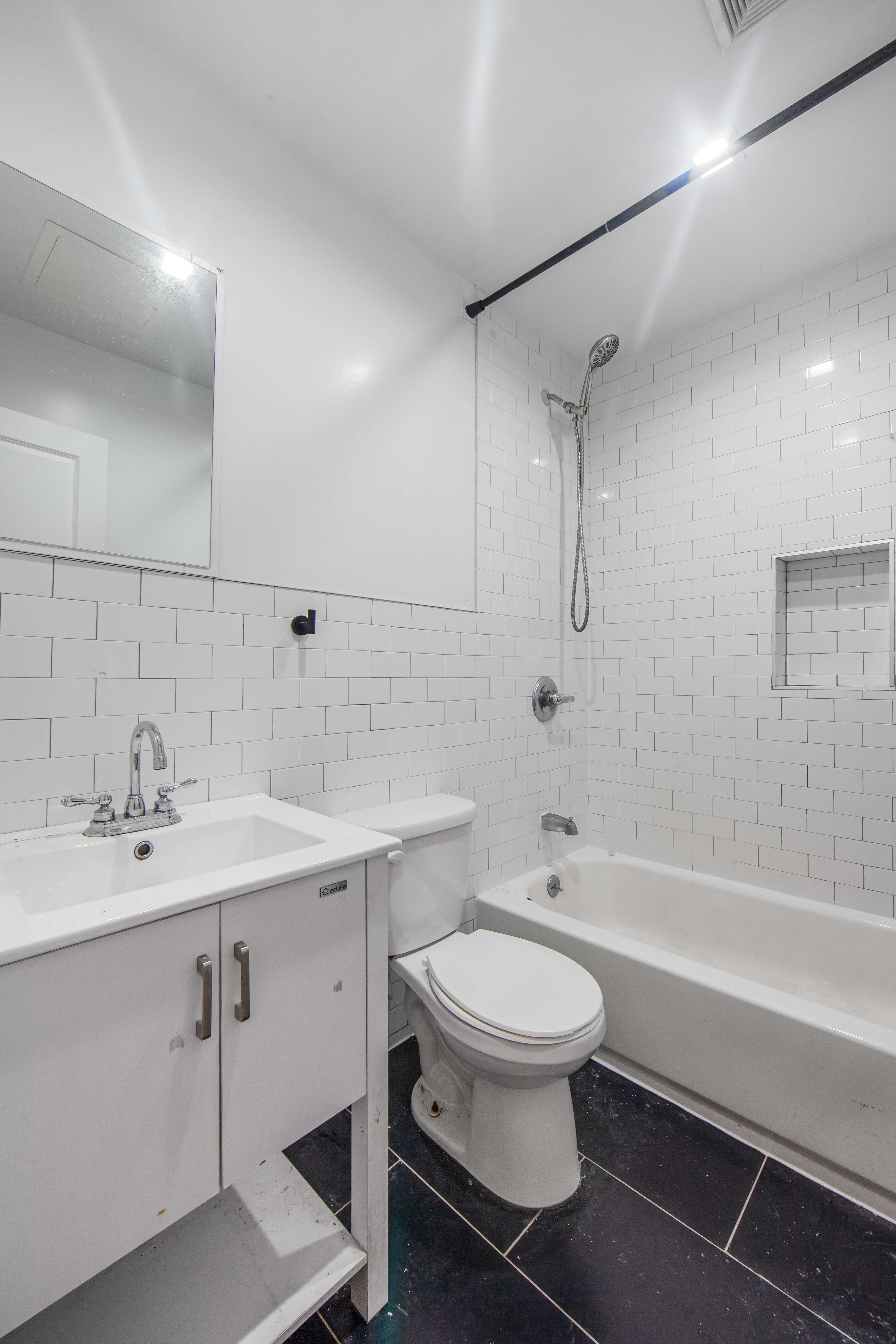 311 East 119th Street, Unit 5 Manhattan, NY 10035 - Photo 4 of 5 a bathroom with a sink toilet and shower