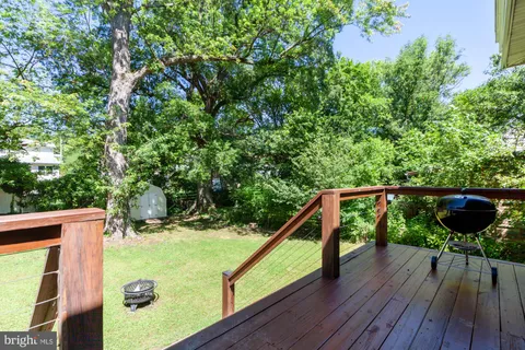 a view of a balcony with wooden floor and outdoor space