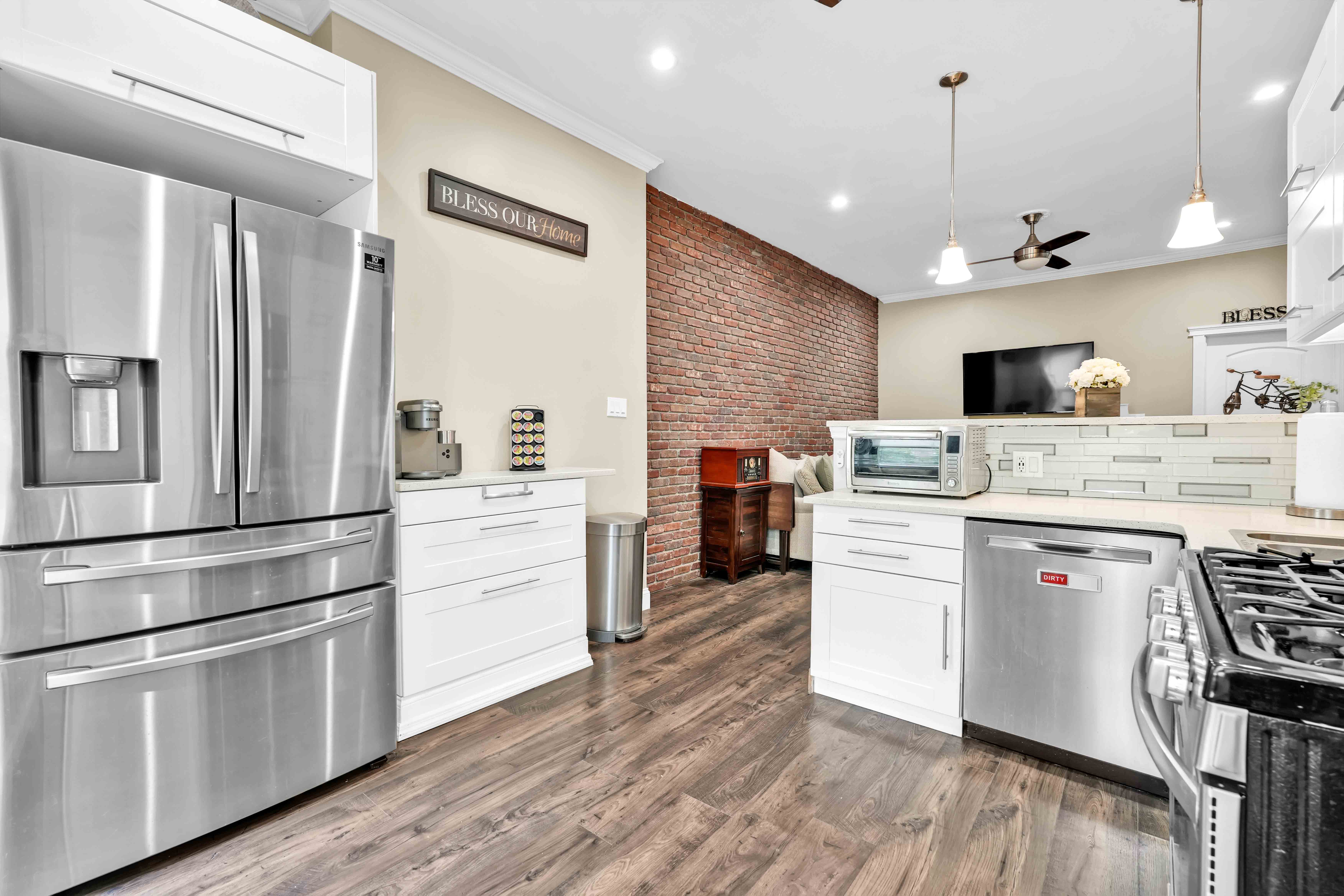 519 Monroe Street Brooklyn, NY 11221 - Photo 13 of 55 a kitchen with a refrigerator stove and white cabinets