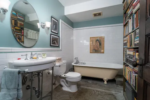a bathroom with a toilet a sink and mirror