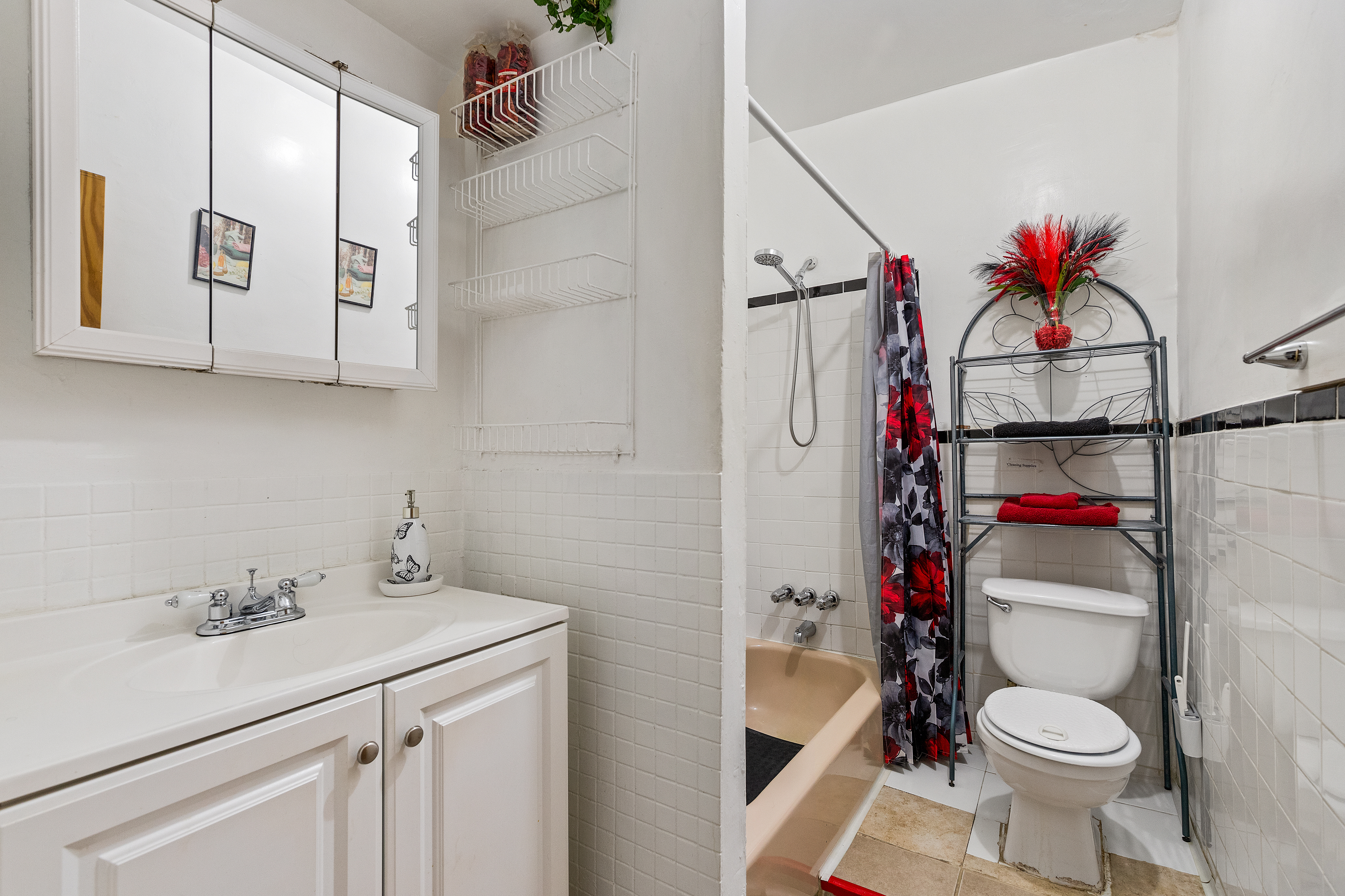415 Monroe Street Brooklyn, NY 11221 - Photo 7 of 9 a bathroom with a sink toilet and shower
