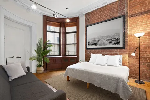 a bedroom with a large bed and a large window