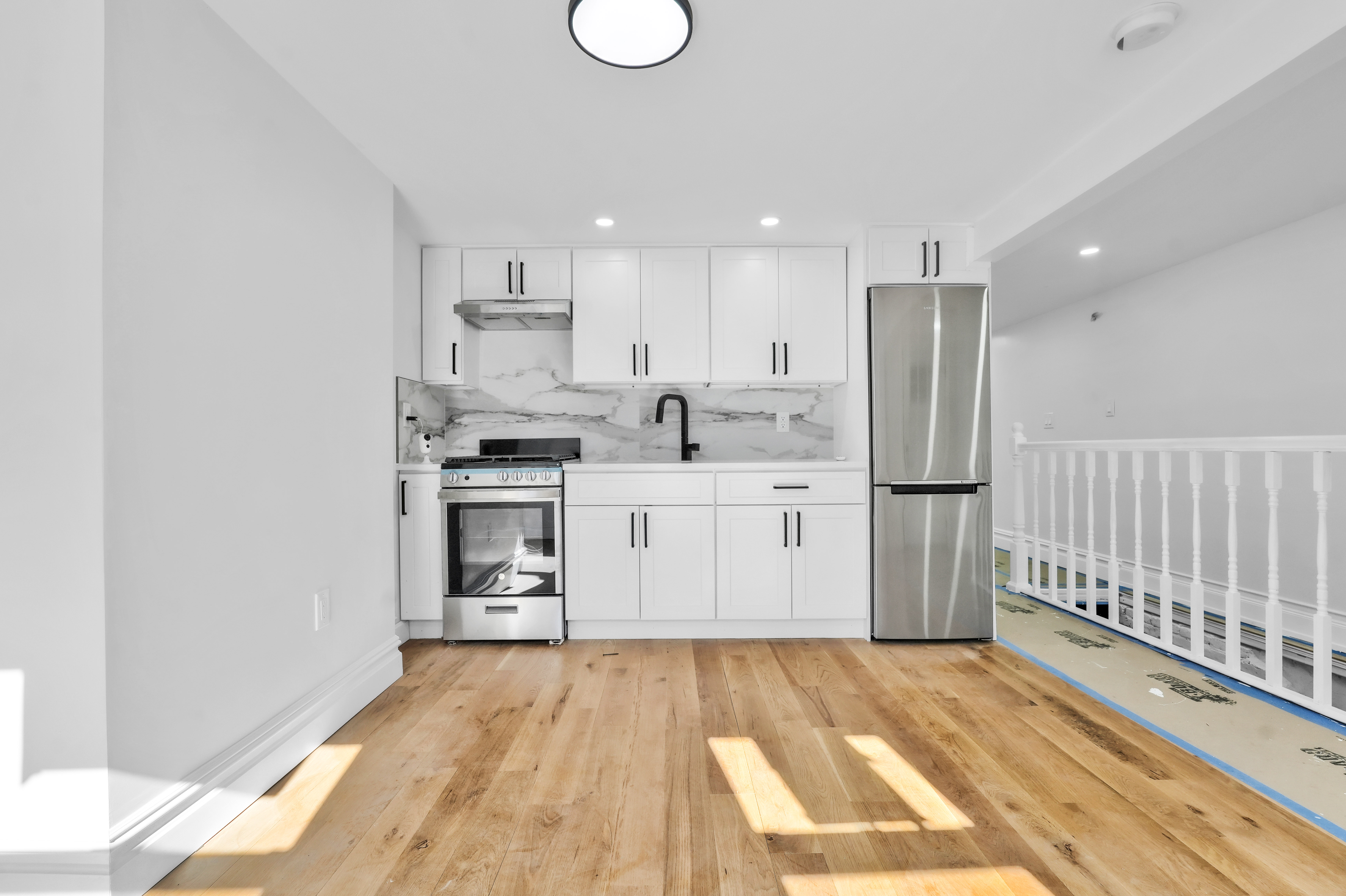473 Monroe Street Brooklyn, NY 11221 - Photo 32 of 40 a kitchen with a refrigerator and a sink