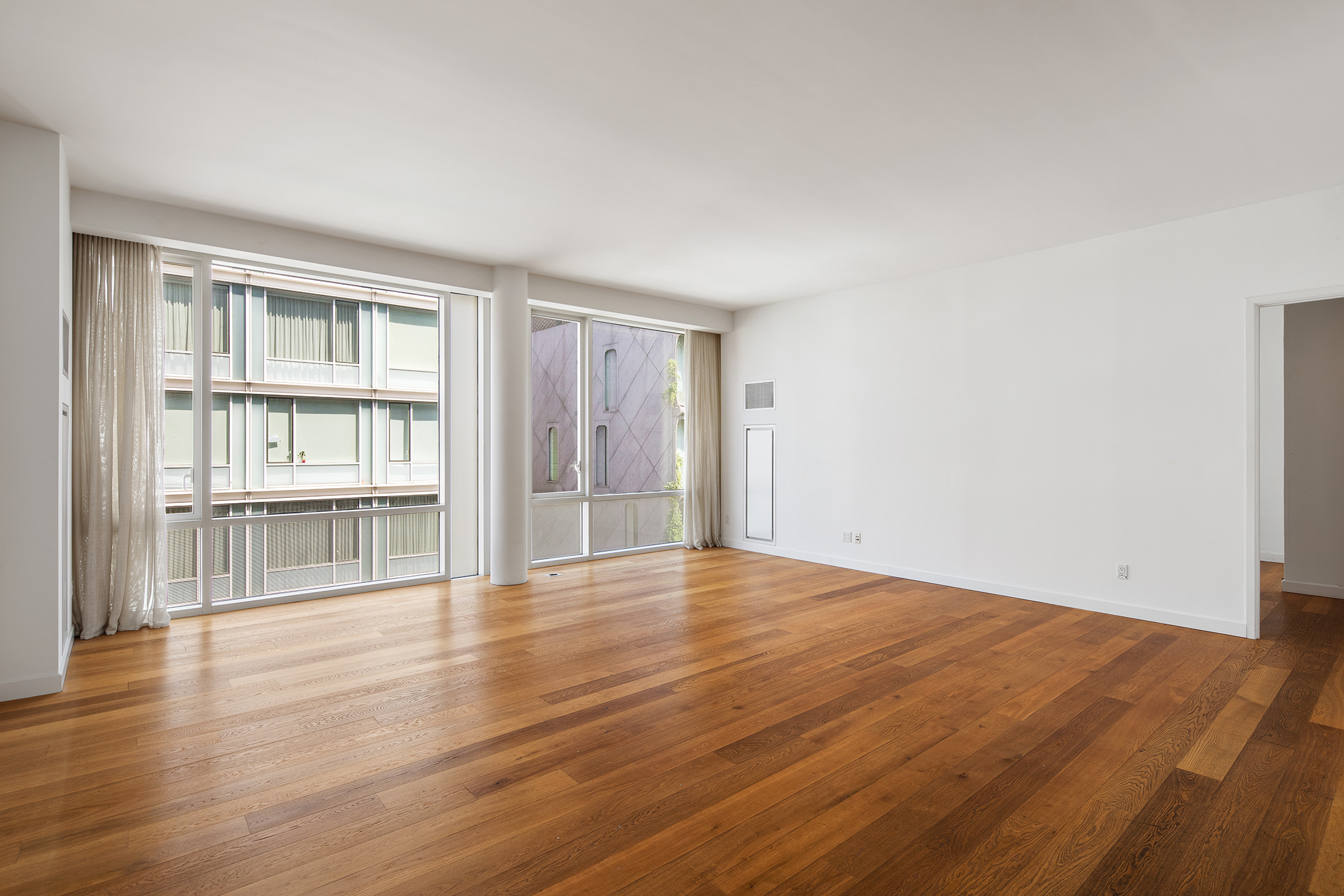 311 West Broadway, Unit 6J Manhattan, NY 10013 - Photo 3 of 19 a view of empty room with wooden floor and fan