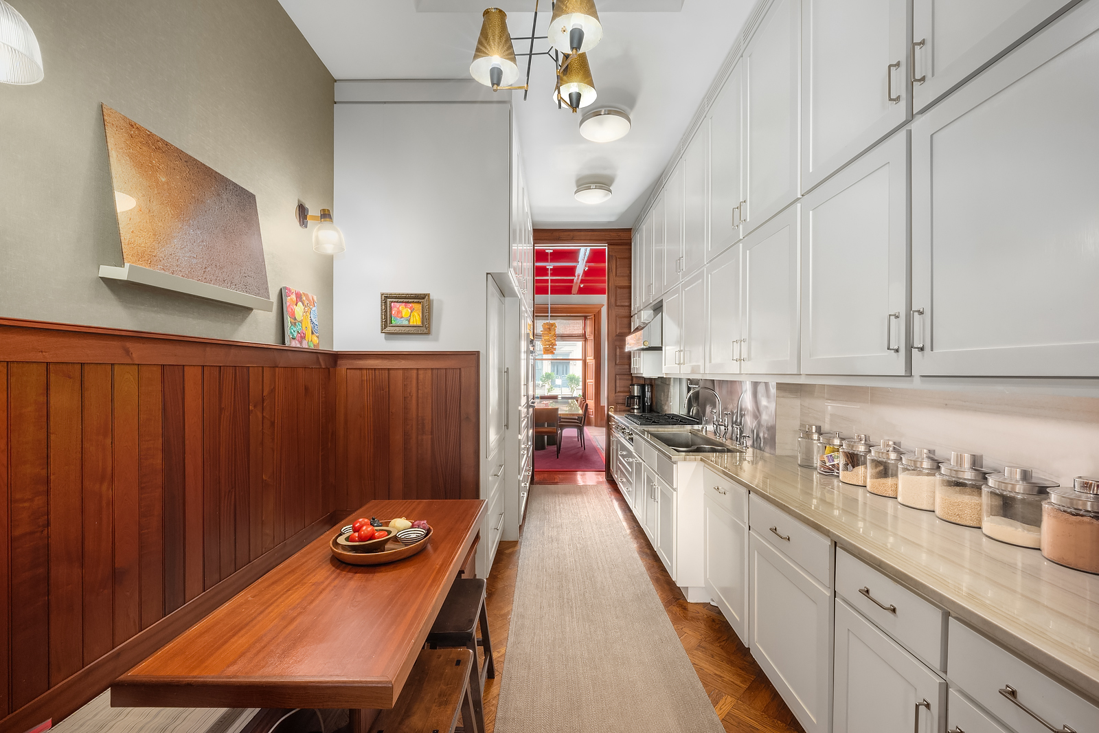 22 West 70th Street Manhattan, NY 10023 - Photo 4 of 12 a kitchen with a refrigerator a stove top oven a sink dishwasher and wooden cabinets