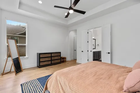 a bedroom with a bed and a ceiling fan