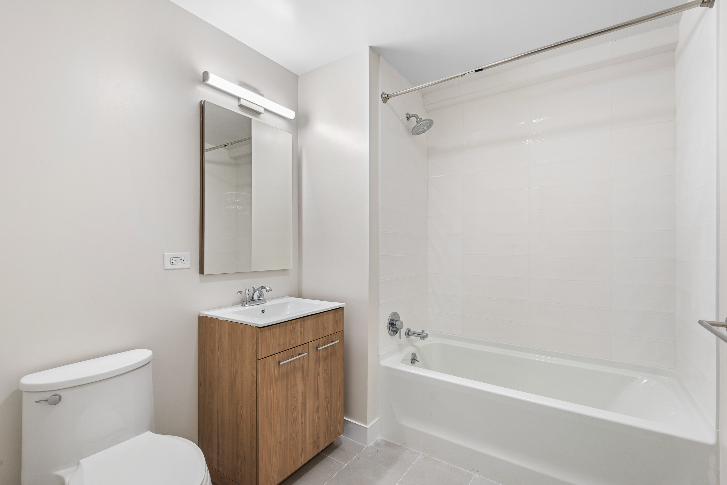 1333 Broadway, Unit 1106 Brooklyn, NY 11221 - Photo 5 of 13 a bathroom with a sink toilet and shower