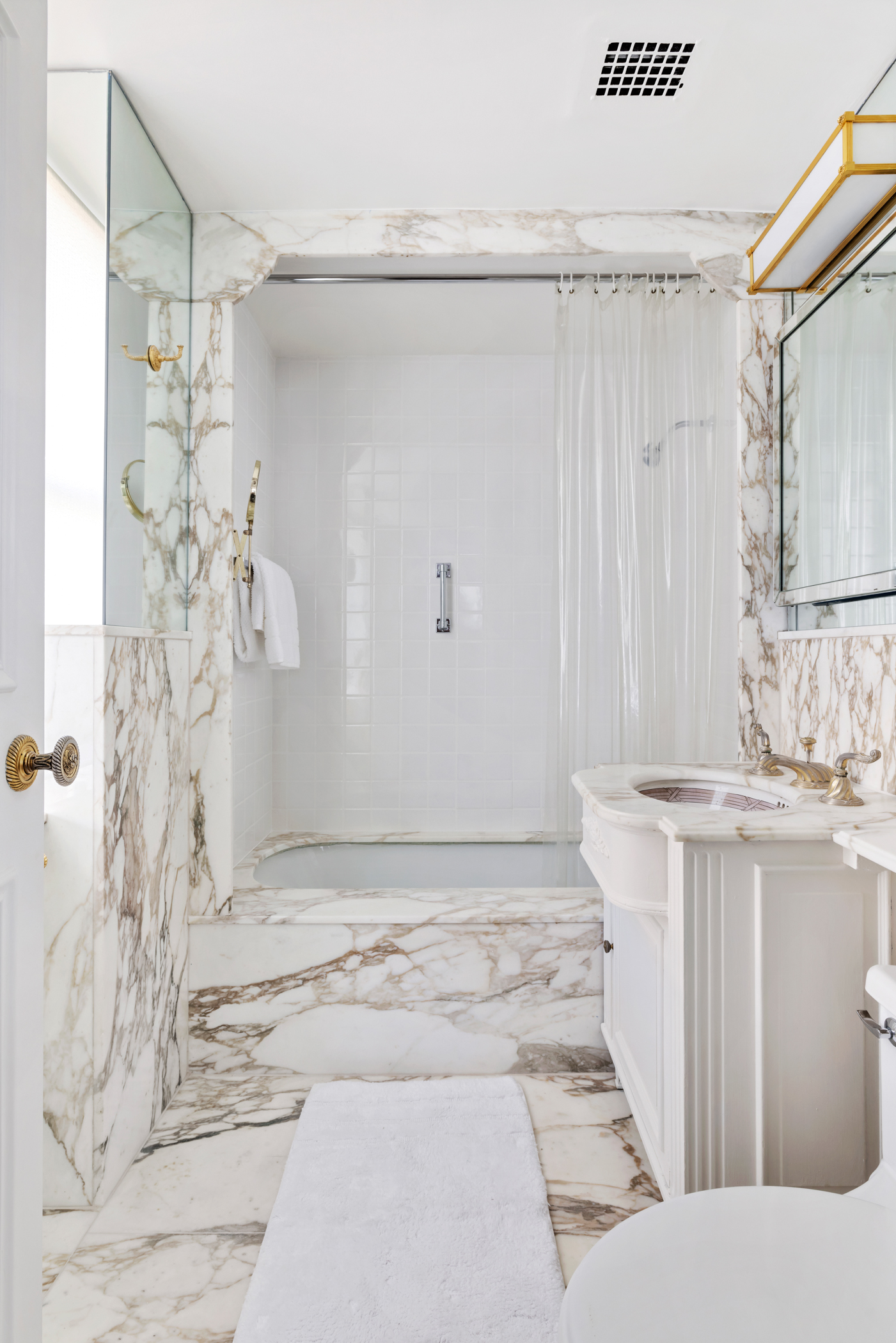 900 5th Avenue, Unit 14C Manhattan, NY 10021 - Photo 8 of 12 a bathroom with a sink and shower