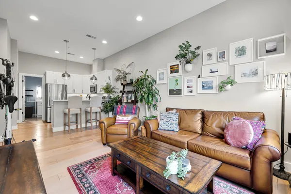 a living room with furniture a fireplace and a flat screen tv